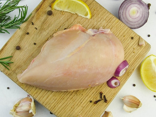 raw chicken breast on a chopping board