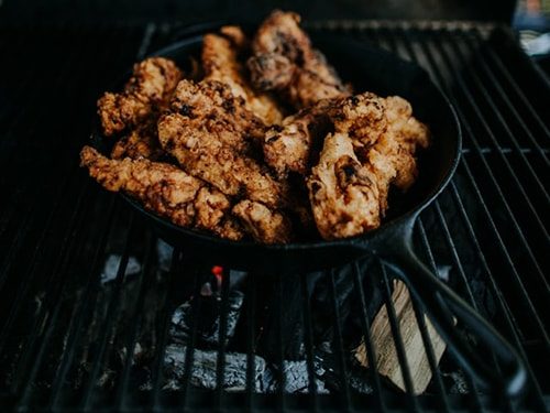 cast iron pan on a cast iron grill