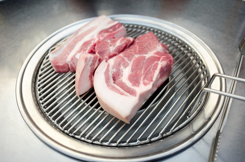 raw pork on a grill