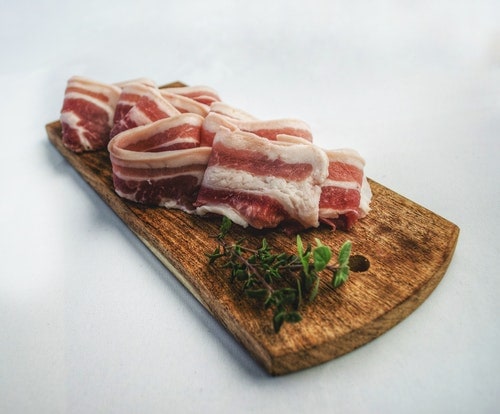 sliced bacon on a board