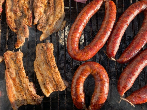 bratwursts on a charcoal grill