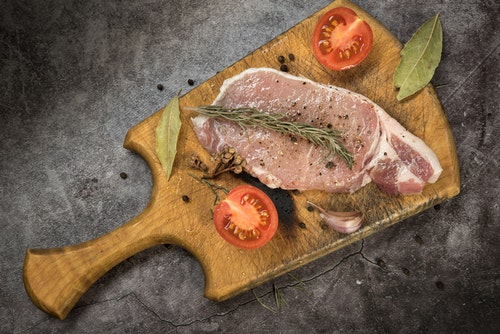 marinated pork on a chopping board