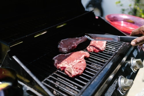 raw meat being grilled