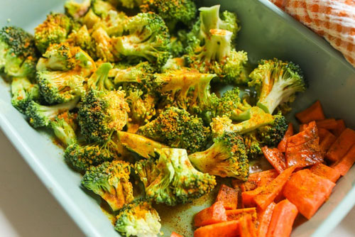 Broccoli and carrots seasoned and ready to be roasted
