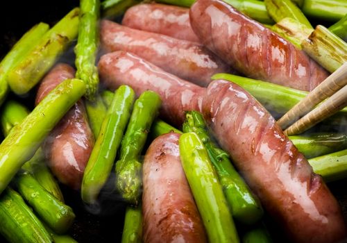 Frying Sausages with Green Asparagus