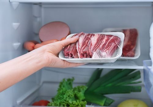 Woman Keeping Meat in Refrigerator