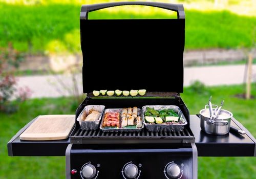 Gas Grill with Veggies and Sausages