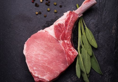 Raw Cut of Pork Chop with Herbs