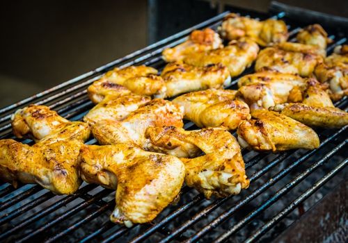 Barbecued chicken wings on grill