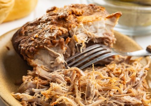 Pulled Pork Meat on a Plate with a Fork