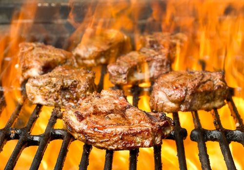 Grilled Lamb Chops Engulfed in Flames on a Barbecue Grill