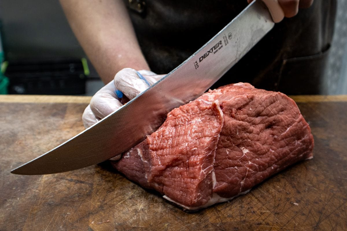 Chef Cutting a Boneless Cut of Meat