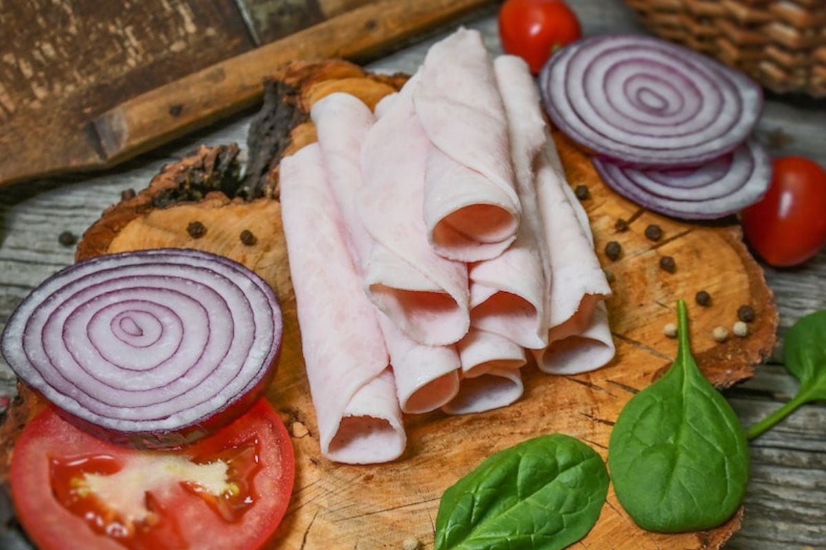 Ham and Sliced Onions on a Wooden Chopping Board