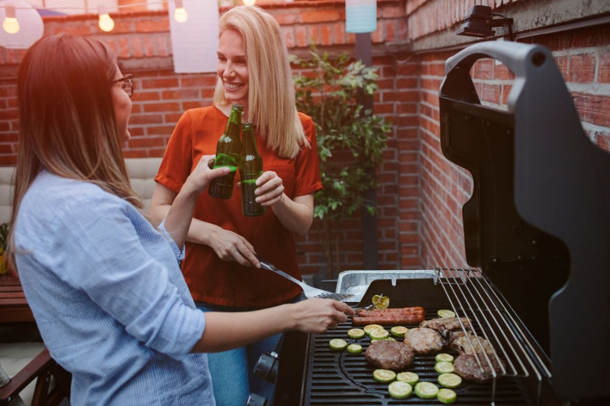 Two Women BBQing Meat and Veggies