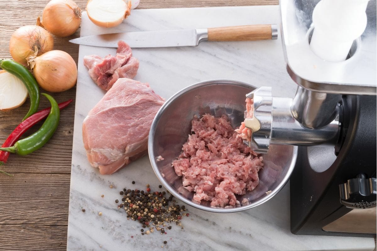 Meat on the Grinder Along with Other Cooking Ingredients