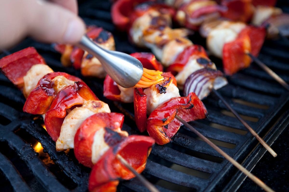 Basting Kebabs on Flaming Barbecue Griddle