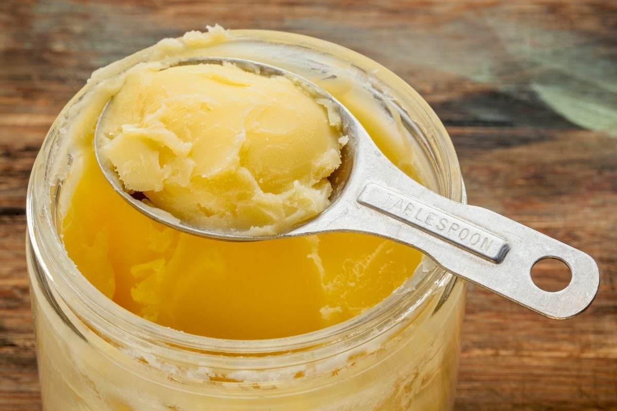 Jar Filled with Animal Fat with a Table Spoon