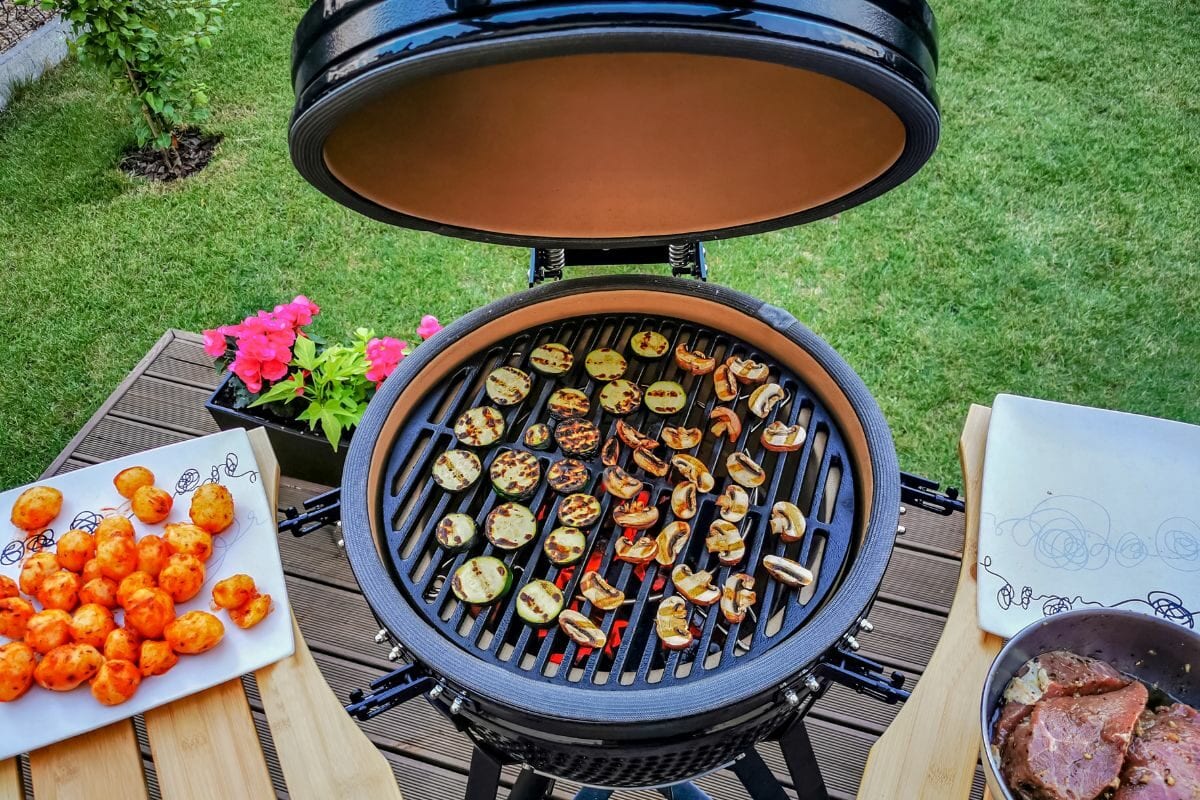 Kamado Type Grill with Beef Steaks and Veggies