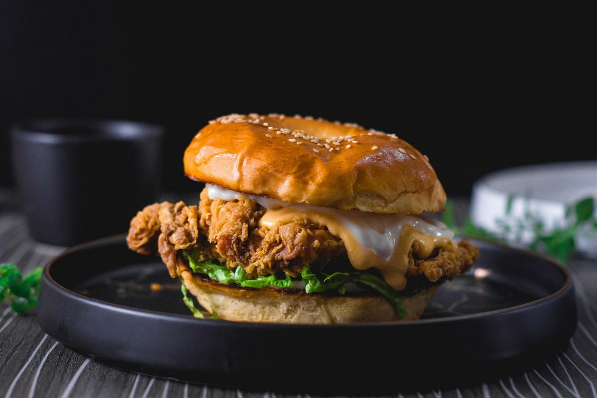 Fried Chicken Sandwich with Cheese on a Black Plate