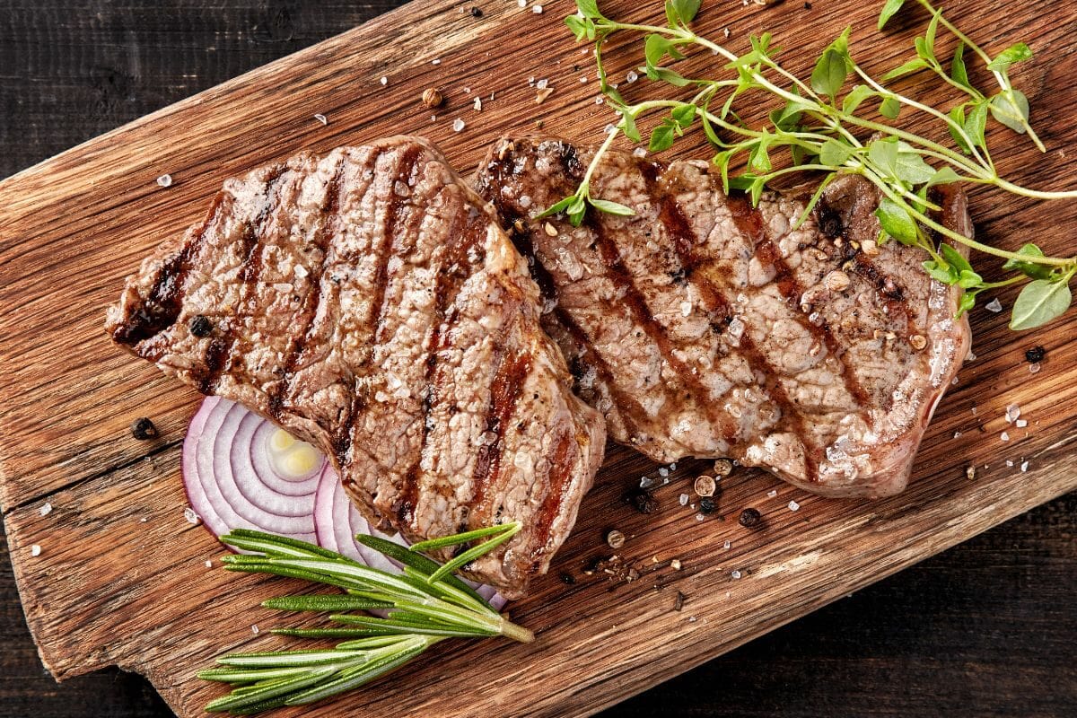 Grilled Beef Steaks on Wooden Board