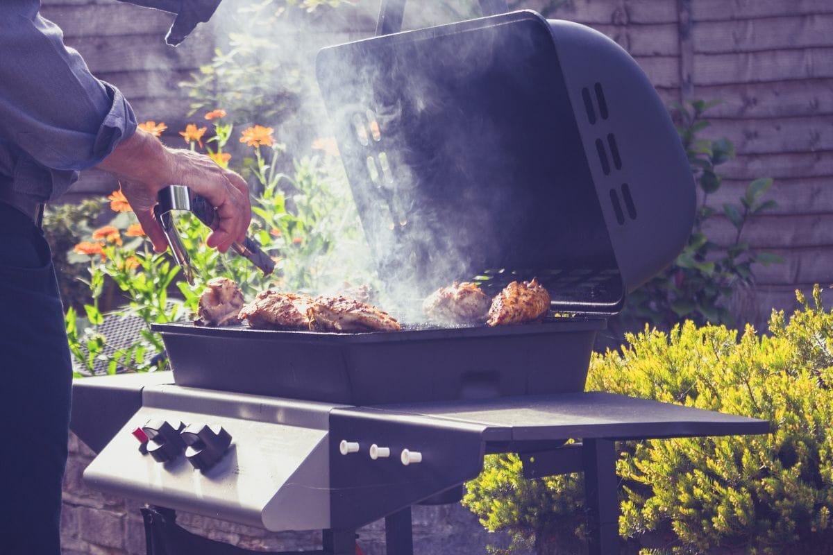 Man Grilling Meat on the Outdoor Grill