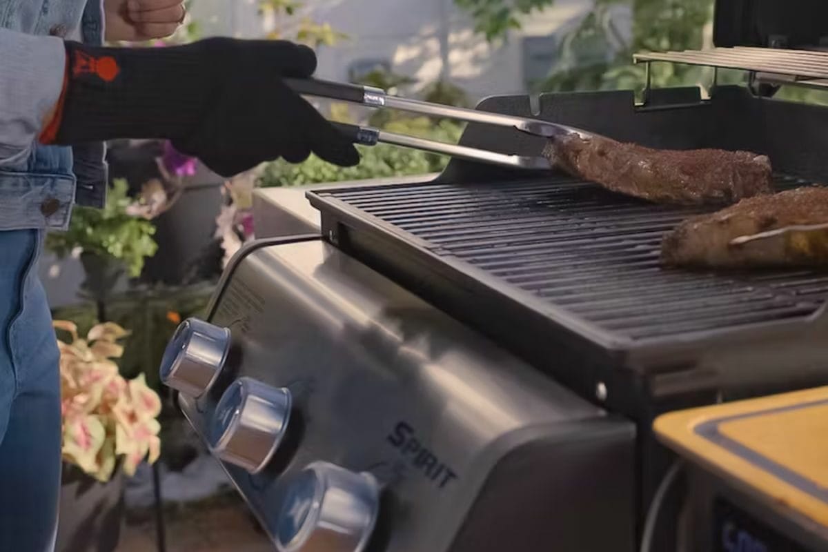 Person Grilling Meat on Spirit SX-315 Smart Grill